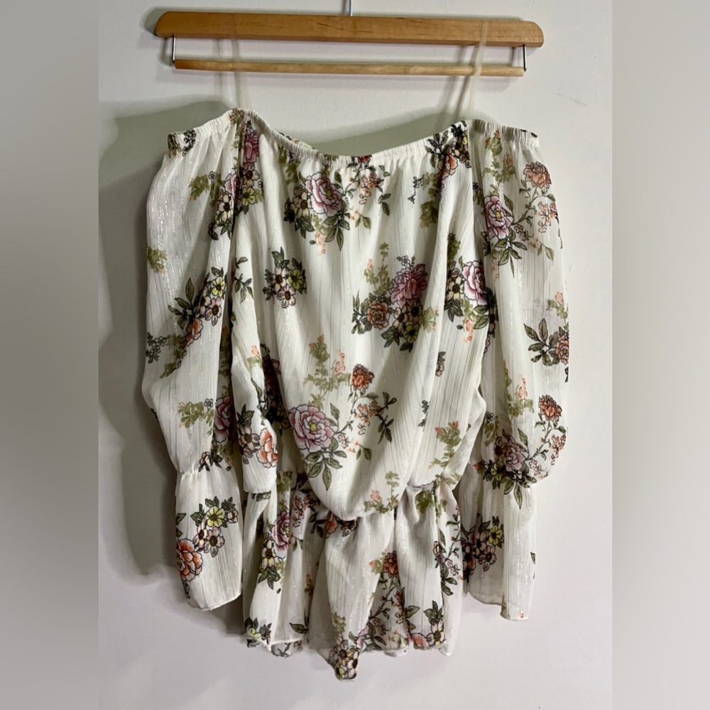 Long sleeve, floral top. Falls off shoulders.
